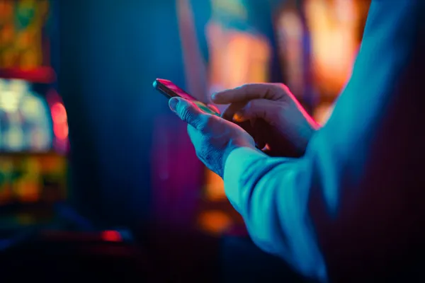 A woman in a luxurious green gown next to an ornate roulette wheel, capturing the upscale casino mood of GETA9.